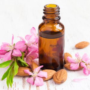 essential oil bottle with spring flowers around it
